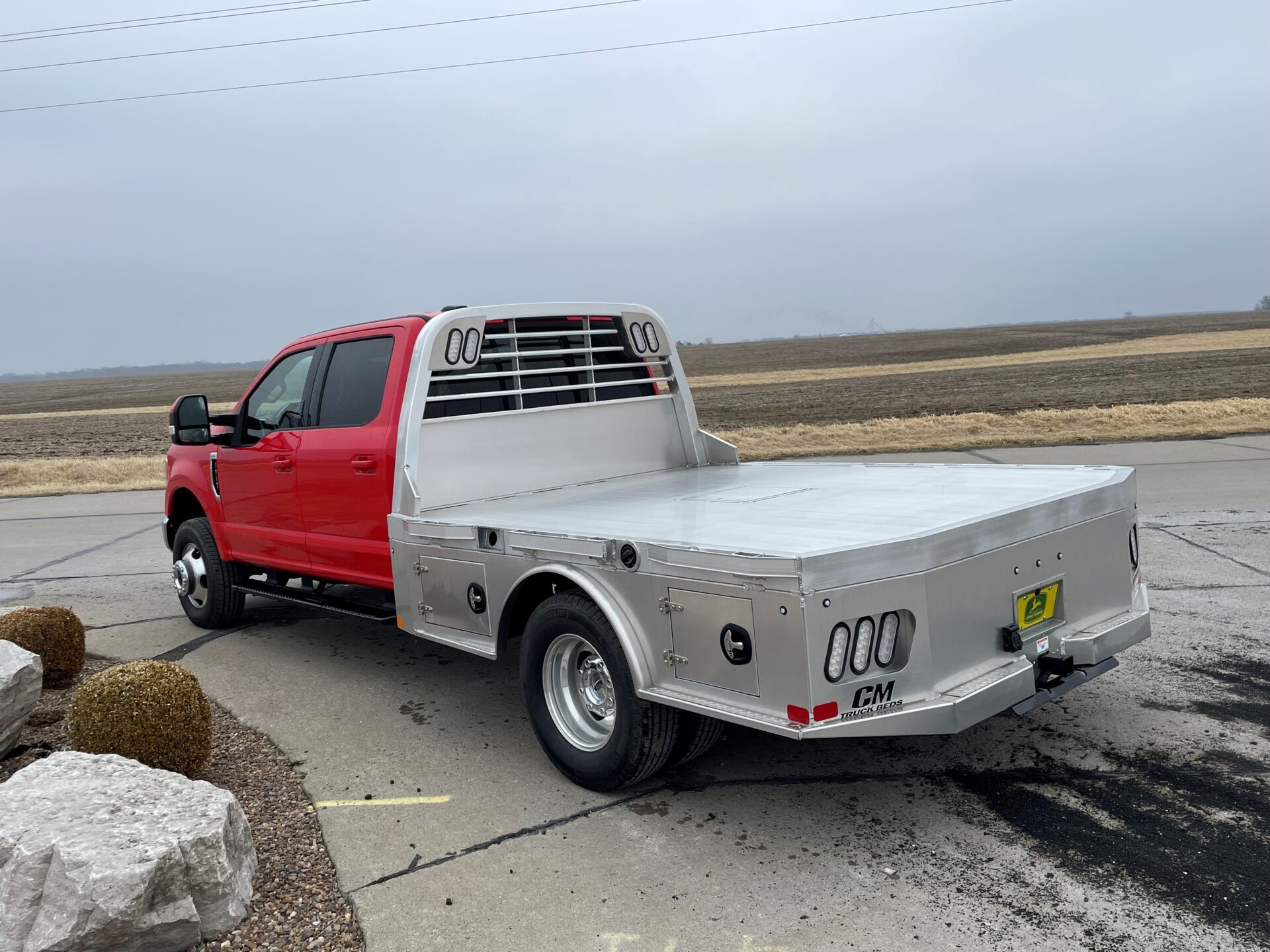 A red truck parked on the side of a road.