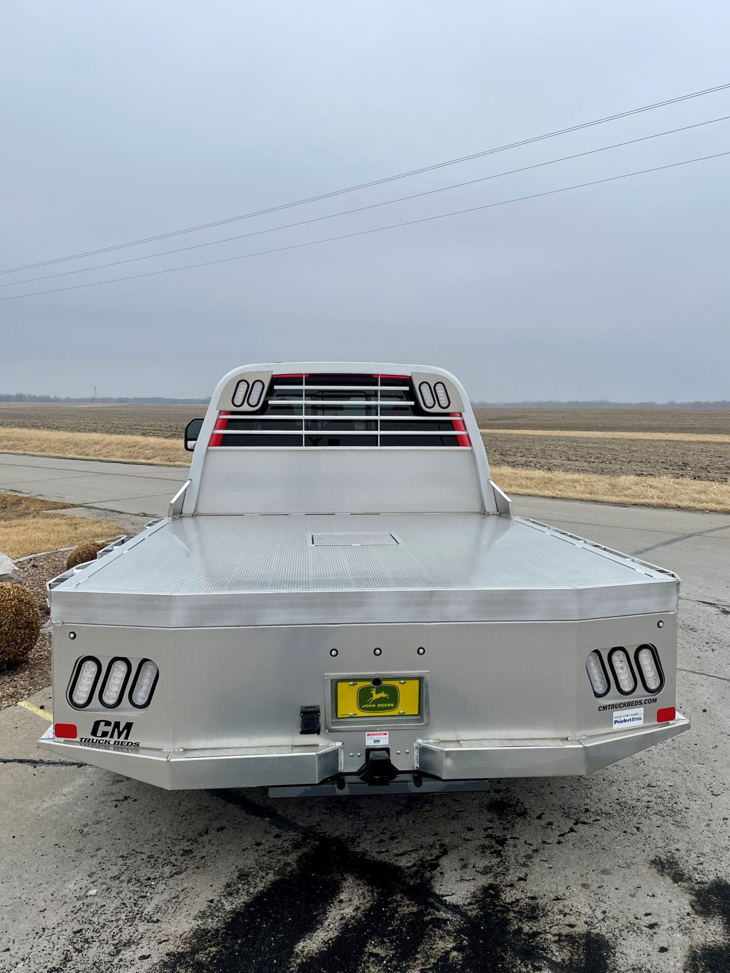 A truck with the back end open on the road.