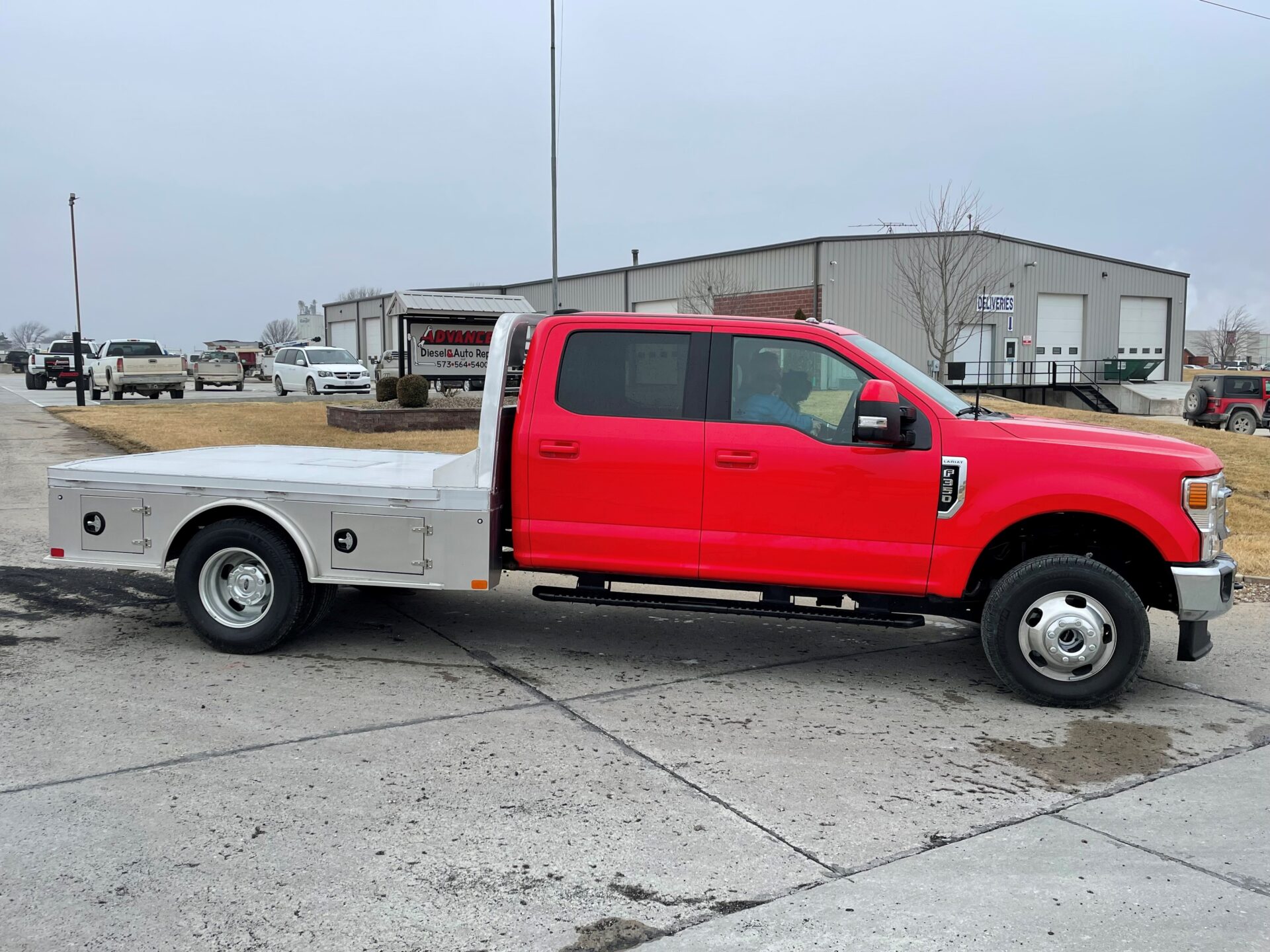 A red truck is parked in the parking lot.